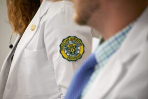 Physician Assistant White Coat with Le Moyne logo
