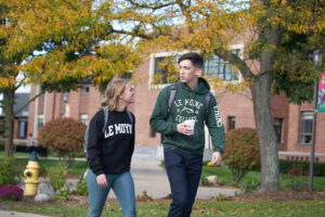 Students walking across campus in the fall
