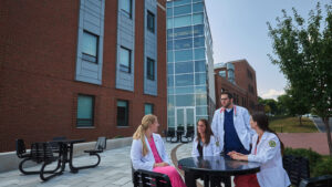 PA Students around a table outside of the Science Center at Le Moyne College