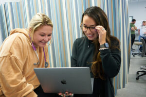 Nursing students working on a laptop