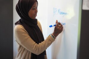 Student at whiteboard in Madden