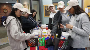 Students making welcome home baskets for A Tiny Home for Good